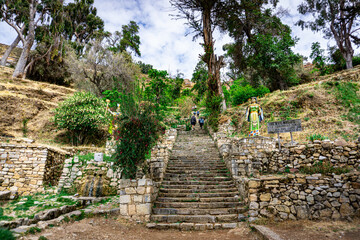 Tourists walking in Ancient Inca Stairs on Isla del Sol Lake Titicaca Bolivia Historic Stone Stairway Surrounded by Stunning Andean Landscape