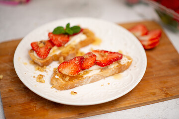 Bruschetta with strawberries. fried in batter toast with cream cheese
