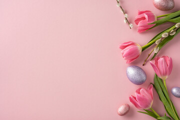 Pink tulips and decorative Easter eggs arranged on a pastel pink surface, evoking springtime vibes. Perfect for holiday, floral themes, and celebrations