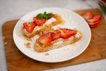 Bruschetta with strawberries. fried in batter toast with cream cheese