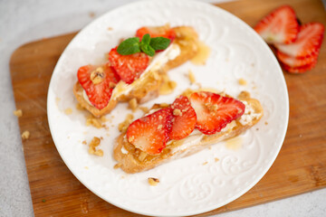 Bruschetta with strawberries. fried in batter toast with cream cheese