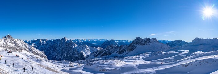 Stunning panorama view of snow covered peaks of Austrian Alps in Tyrol from Zugspitzplatt on a sunny day in winter, Garmisch-Partenkirchen, Bavaria, Germany
