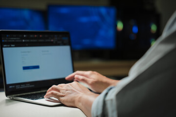 Cropped shot of young businessman hand typing on laptop computer while working in office room.