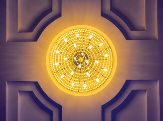 A glowing chandelier hangs from the ceiling