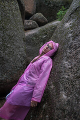 Woman in the taiga forest and rocks of the Stolby nature reserve park