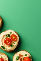 Creamy hummus topped with fresh tomatoes and herbs on toasted br