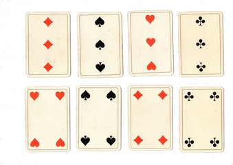 Antique playing cards showing four of the same value.