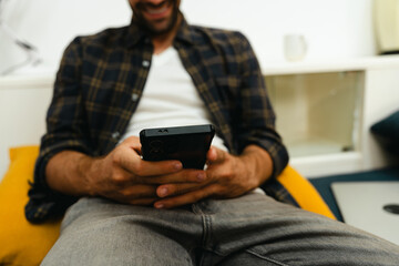 Close-up of man's hand playing with mobile phone
