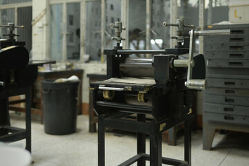 A classic printing press machine stands in a workshop, Crafting Graphic Art concept