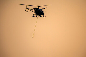 Silhouette helicopter resque utensils during dawn