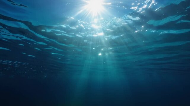 Underwater deep blue ocean background with ripple, wave lights, and sun rays, copy space