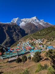 Town with houses of different colors with snowy mountains in the background