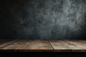 an empty wooden table in front of a dark wall