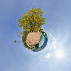 simple little tiny planet without buildings in blue sky with sun and beautiful clouds....