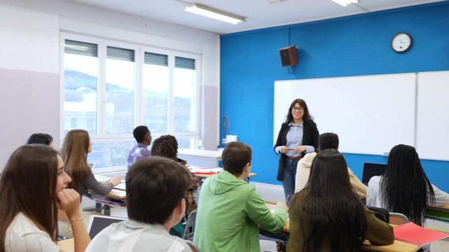 High school teacher giving lesson to diverse group of students