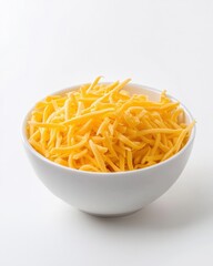 Bowl of shredded yellow cheese against white background, implying comfort food and simple pleasures. Ideal for culinary blogs, recipe posts, and food preparation.