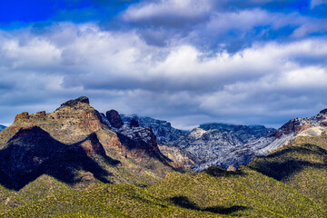 2023-03-02 CATALINA MOUNTAINS WITH SNOW AND A GREEN VALLEY IN MARCH WITH A GRAY SKY JUST OUTSIDE OF TUCSON ARIZONA