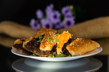 cooked simple puff pastries with mushroom filling isolated on black background