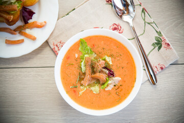 Thick and creamy cream soup of trout in a plate