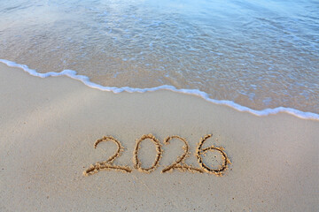 2026 hand written in sand on a beautiful beach