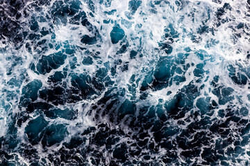 Sea water surface background. Aerial view of stylish foamy water. Can be used in covers, packaging, posters, textures, wallpapers, art and design projects. Vibrant nature background image.