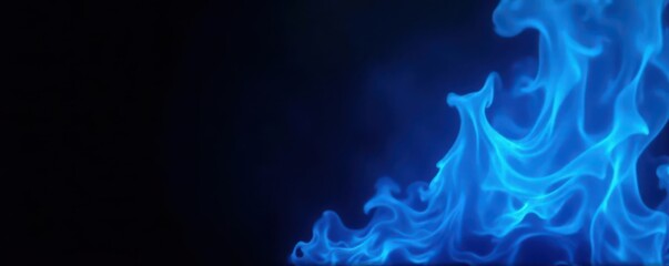Fototapeta premium Intense blue fire bursts against a completely black background , cool, glowing, image