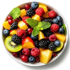 Obraz premium Fresh Mixed Fruit in a White Bowl with Mint Garnish in Natural Light