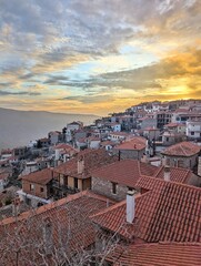 The mountain town of Arachova, Greece, basks in a golden sunset, illuminating the rooftops and landscape
