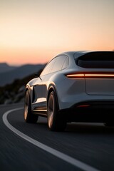 Sleek electric car curves along winding road, illuminated by sun