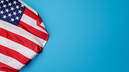 Fototapeta premium American Flag Waving on Bright Blue Background Symbolizing Patriotism and Independence Celebration