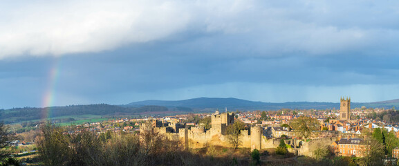 Last sunlight of the day over the town of Ludlow in Shropshire, UK after a rain storm with a partial rainbow © Richard O'Donoghue