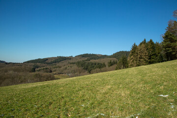 Rolling Hills and Green Fields Under a Clear Sky. A stunning countryside landscape featuring...