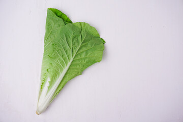 Fresh green color lettuce salad leaves isolated close up white background. Top view. Selective focus.