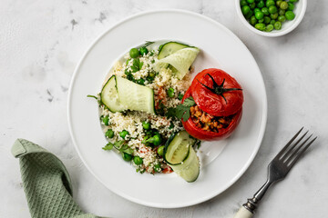 The concept of healthy eating. Turkey-stuffed tomatoes with whole wheat couscous salad