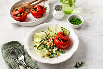 The concept of healthy eating. Turkey-stuffed tomatoes with whole wheat couscous salad