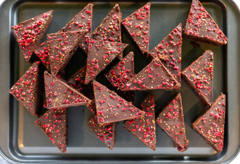 Heap of decorated chocolate cake on plate