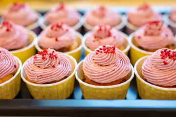Group of delicious muffins with tasty cream topping