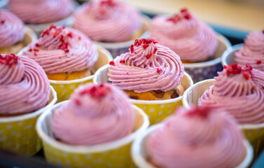 Group of delicious muffins with tasty cream topping