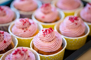 Group of delicious muffins with tasty cream topping