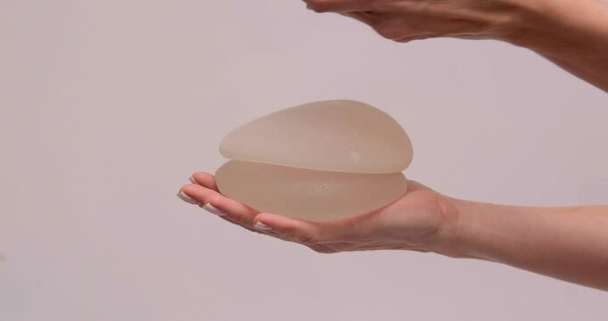 doctor holding breast enlargement implant in hands, plastic surgery concept, beauty enhancement, medical Mammoplasty and plastic surgery, mastopexy