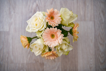 bouquet of colorfull Gerbera flowers and white roses on a wooden background with negative space	