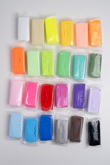 Set of colored plasticine for creativity. Plasticine dough for modeling in transparent packaging. Banner design