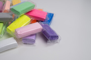 Set of colored plasticine for creativity. Plasticine dough for modeling in transparent packaging. Banner design