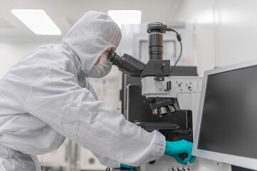 Scientist in laboratory,research experiment using microscope,lab work and sample analysis,scientific research process.