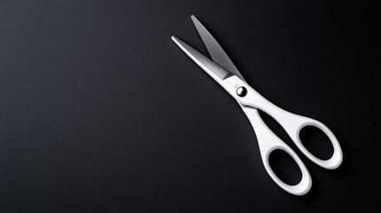 White scissors on black background; simple, clean design