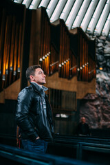 A man on the background of an ancient organ in a church