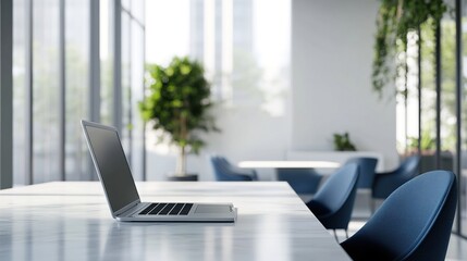 A Laptop Placed on a White Table in an Office Space with Green Plants and Chairs in the Background