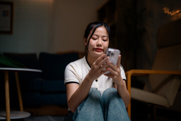 Young Woman Using Smartphone at Home in Living Room