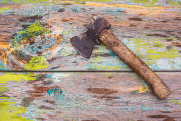 Old ax on isolated wooden background.