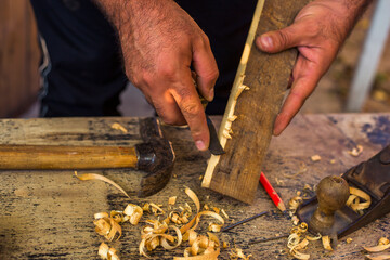 The carpenters are using spokeshave to decorate the woodwork.
